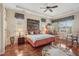 Spacious main bedroom featuring tray ceilings, plantation shutters, and hardwood floors at 5412 Royal Poinciana Way, North Port, FL 34291