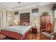 Bright main bedroom boasts a decorative wall piece, plantation shutters, and stylish decor at 5412 Royal Poinciana Way, North Port, FL 34291