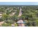 Expansive aerial view of homes with pools nestled among lush green trees in a residential neighborhood at 5712 Garden Lakes Fern, Bradenton, FL 34203
