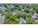 Aerial view showcasing the community pool, parking area, and surrounding lush greenery at 5712 Garden Lakes Fern, Bradenton, FL 34203