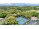 Aerial view of community tennis courts, lush green landscaping, and parking at 5712 Garden Lakes Fern, Bradenton, FL 34203