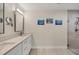 Bathroom with double vanity sinks and a tiled walk-in shower at 5712 Garden Lakes Fern, Bradenton, FL 34203