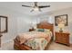 This bedroom has a ceiling fan and two dressers with a closet at 5712 Garden Lakes Fern, Bradenton, FL 34203