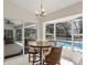 Bright breakfast nook with a round table overlooking a pool and screened-in patio at 5712 Garden Lakes Fern, Bradenton, FL 34203