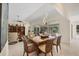 The dining room has a wooden table with stylish chairs and sliding glass doors to the lanai at 5712 Garden Lakes Fern, Bradenton, FL 34203