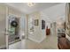 Bright entryway with tile flooring, decorative artwork, and a clear view to the front yard through the front door at 5712 Garden Lakes Fern, Bradenton, FL 34203