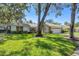 Beautifully landscaped front yard with mature trees, offering shade and enhancing the home's curb appeal at 5712 Garden Lakes Fern, Bradenton, FL 34203