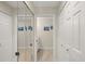 Well-lit hallway featuring mirrored closet doors and access to bathroom and other rooms at 5712 Garden Lakes Fern, Bradenton, FL 34203