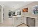 Open kitchen with white cabinetry, an island, and a sliding door to the pool at 5712 Garden Lakes Fern, Bradenton, FL 34203