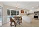 Bright kitchen nook with a cozy breakfast table and views of the screened-in pool through large windows at 5712 Garden Lakes Fern, Bradenton, FL 34203