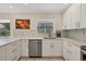 Kitchen with stainless steel appliances, white cabinetry, and a view to the pool at 5712 Garden Lakes Fern, Bradenton, FL 34203