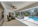 Enclosed lanai with ample seating, a ceiling fan, and view of pool and landscaping at 5712 Garden Lakes Fern, Bradenton, FL 34203