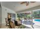 Outdoor lounge area on screened-in lanai with seating and view of backyard at 5712 Garden Lakes Fern, Bradenton, FL 34203