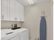 Neat laundry room equipped with modern washer, dryer, and storage cabinets at 5712 Garden Lakes Fern, Bradenton, FL 34203