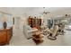 Bright living room showcases stylish decor, tile flooring, and backyard views at 5712 Garden Lakes Fern, Bradenton, FL 34203