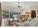 Spacious living area with a view of the pool and outdoor seating area through glass doors at 5712 Garden Lakes Fern, Bradenton, FL 34203