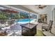 Enjoy an outdoor space with patio seating, barbecue, and a screened-in pool view at 5712 Garden Lakes Fern, Bradenton, FL 34203