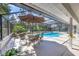 Outdoor dining set near a screened-in pool, perfect for entertaining guests or relaxing outdoors at 5712 Garden Lakes Fern, Bradenton, FL 34203