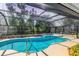 Inground pool with screened in enclosure and view of the treeline at 5712 Garden Lakes Fern, Bradenton, FL 34203