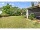 Expansive backyard featuring a lush lawn, established hedges, a playset, and a screened lanai at 5907 90Th Avenue E Cir, Parrish, FL 34219
