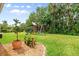 Landscaped backyard featuring a playset and mature trees, creating a serene outdoor space at 5907 90Th Avenue E Cir, Parrish, FL 34219