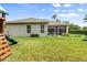 Spacious backyard with a play set and a screened patio, perfect for entertaining and relaxation at 5907 90Th Avenue E Cir, Parrish, FL 34219