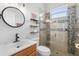 Modern bathroom with glass enclosed shower, vanity with faucet, and floating shelves at 5907 90Th Avenue E Cir, Parrish, FL 34219
