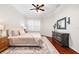 Comfortable bedroom with hardwood floors, plantation shutters, and a stylish ceiling fan at 5907 90Th Avenue E Cir, Parrish, FL 34219