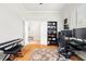 Home office with natural light, wood floors, multiple monitors, and a black bookshelf at 5907 90Th Avenue E Cir, Parrish, FL 34219