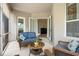 Cozy covered patio with comfortable seating and French door access to the interior at 5907 90Th Avenue E Cir, Parrish, FL 34219