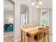 Bright dining area features wooden table, decorative rug runner and natural light from nearby door at 5907 90Th Avenue E Cir, Parrish, FL 34219