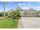 Beautifully landscaped home featuring a well-kept lawn and a spacious three-car garage at 5907 90Th Avenue E Cir, Parrish, FL 34219