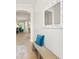 Inviting hallway with decorative mirror, a bench with cushion, and views into other rooms at 5907 90Th Avenue E Cir, Parrish, FL 34219