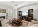 Spacious living room with built-in shelving, fireplace, decorative rug, and neutral paint at 5907 90Th Avenue E Cir, Parrish, FL 34219
