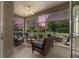 Inviting screened porch with wicker furniture, a ceiling fan, and views of the sunset at 5907 90Th Avenue E Cir, Parrish, FL 34219