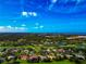 Aerial view of a luxurious home situated within a golf course community, surrounded by mature trees at 600 Eagle Watch Ln, Osprey, FL 34229
