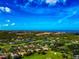Breathtaking aerial view of a lush golf course community with beautiful homes and stunning coastal scenery on a sunny day at 600 Eagle Watch Ln, Osprey, FL 34229