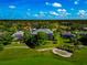 Lovely aerial view showcasing a home near a golf course with a pristine sand trap and mature landscaping on a bright day at 600 Eagle Watch Ln, Osprey, FL 34229