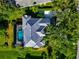 Aerial view of the property with a screened pool enclosure, lush landscaping, and mature trees at 600 Eagle Watch Ln, Osprey, FL 34229
