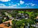 Aerial view of a well-maintained home featuring mature trees, manicured lawns, and serene surroundings within a golf course community at 600 Eagle Watch Ln, Osprey, FL 34229