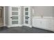 Bathroom with modern white cabinets, grey tile flooring and three panel doors at 600 Eagle Watch Ln, Osprey, FL 34229