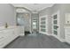 Bathroom with a modern shower featuring marbled tile and glass doors plus white vanity at 600 Eagle Watch Ln, Osprey, FL 34229