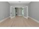 Bright room boasts hardwood floors and double french doors that lead to other rooms at 600 Eagle Watch Ln, Osprey, FL 34229