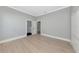 Bright room with hardwood floors offers seamless flow to the ensuite bathroom and walk-in closet at 600 Eagle Watch Ln, Osprey, FL 34229