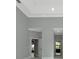 Bedroom with tray ceiling, neutral paint, and bright doorway to a hallway at 600 Eagle Watch Ln, Osprey, FL 34229