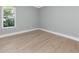 Bright bedroom with hardwood floors is enhanced by a window with a beautiful view at 600 Eagle Watch Ln, Osprey, FL 34229