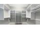 Walk-in closet with custom shelving and ample storage space with overhead racks at 600 Eagle Watch Ln, Osprey, FL 34229