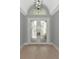 Bright foyer featuring double doors with decorative glass and light hardwood floors at 600 Eagle Watch Ln, Osprey, FL 34229