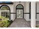 Elegant front entryway with arched windows and double doors flanked by white columns at 600 Eagle Watch Ln, Osprey, FL 34229