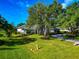 Beautiful home with well-manicured lawn, mature trees, and a circular driveway at 600 Eagle Watch Ln, Osprey, FL 34229